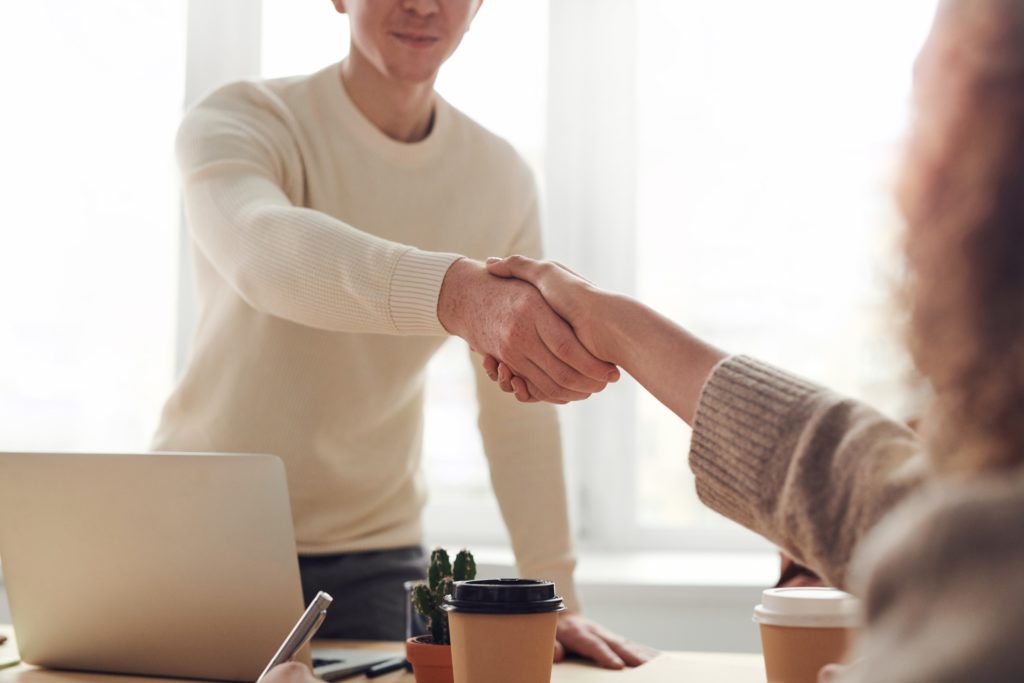 Two people shaking hand.  Showing people greeting in a friendly manner to discuss their septic system.